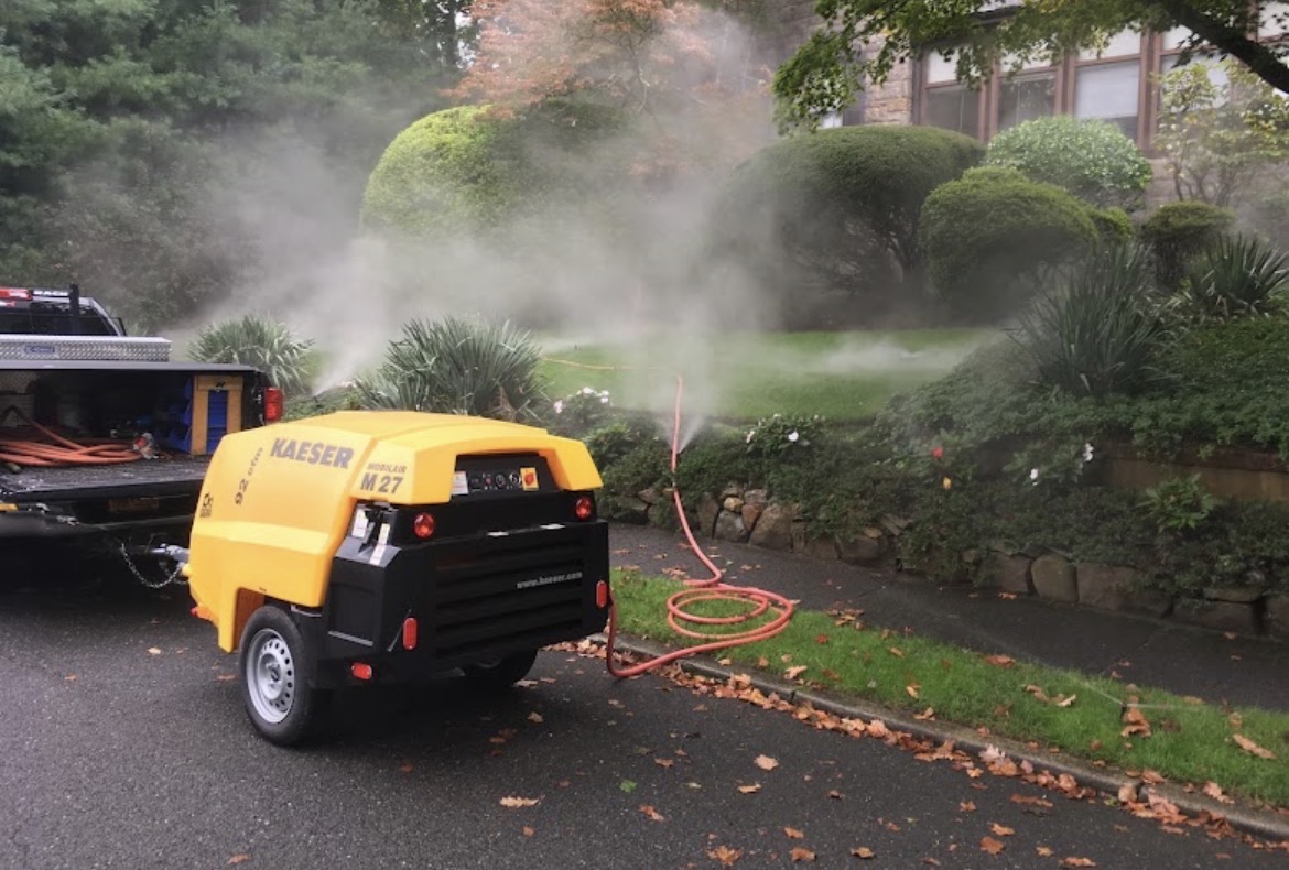 Irrigation winterization blow-out clearing sprinkler lines with a Kaeser compressor at a Rockland County estate